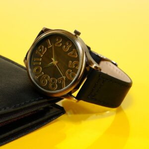 Noir Dress Automatic — slim black-dial dress watch on a clean neutral studio background